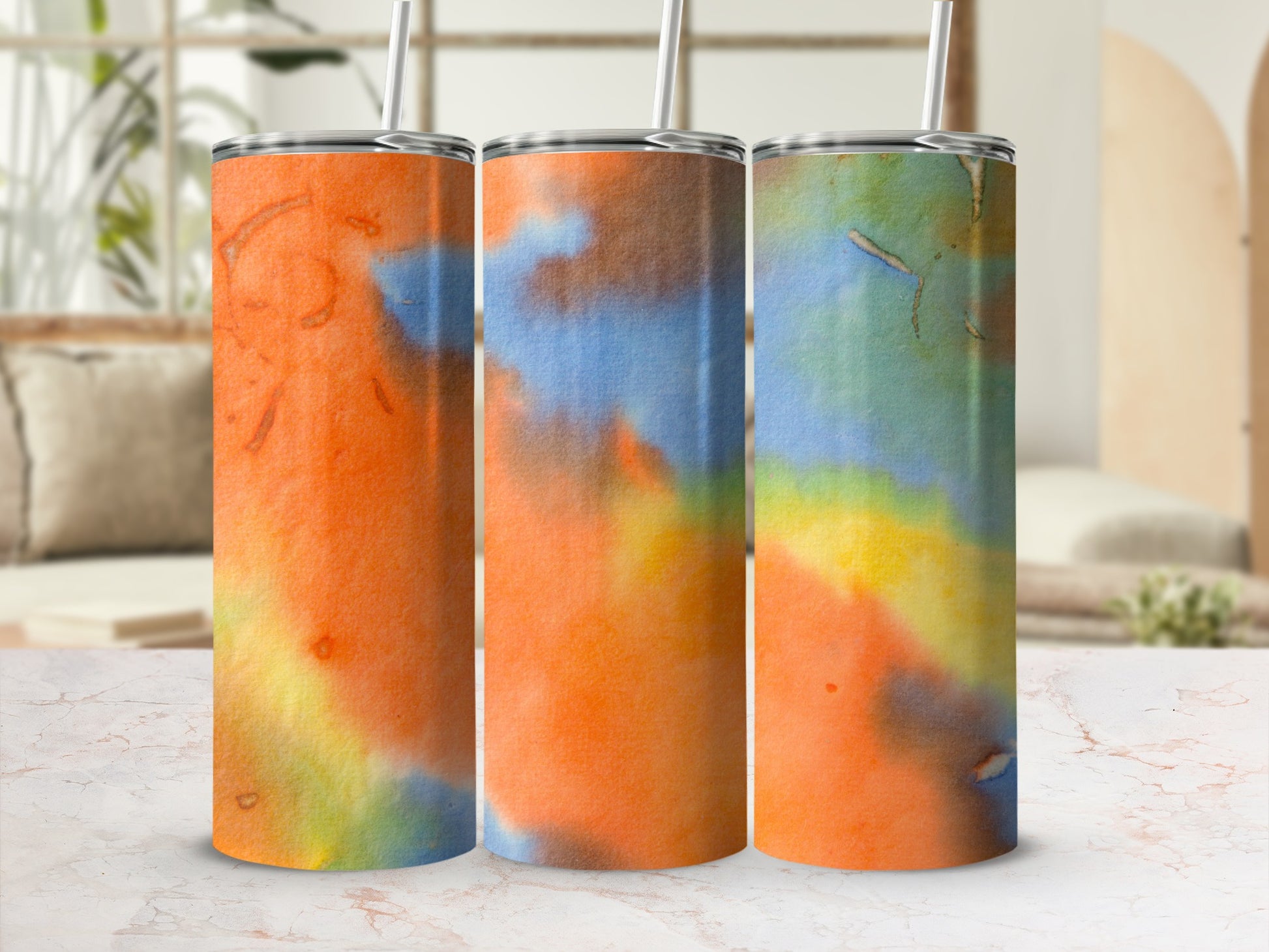 Three tumblers with colorful abstract watercolor designs.