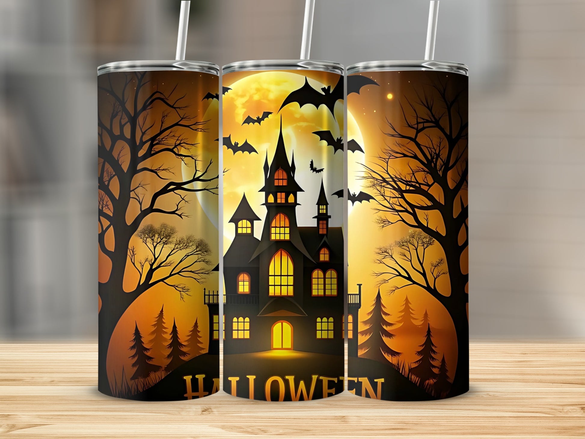 Three tumblers featuring a haunted house, bats, and the word "Halloween".