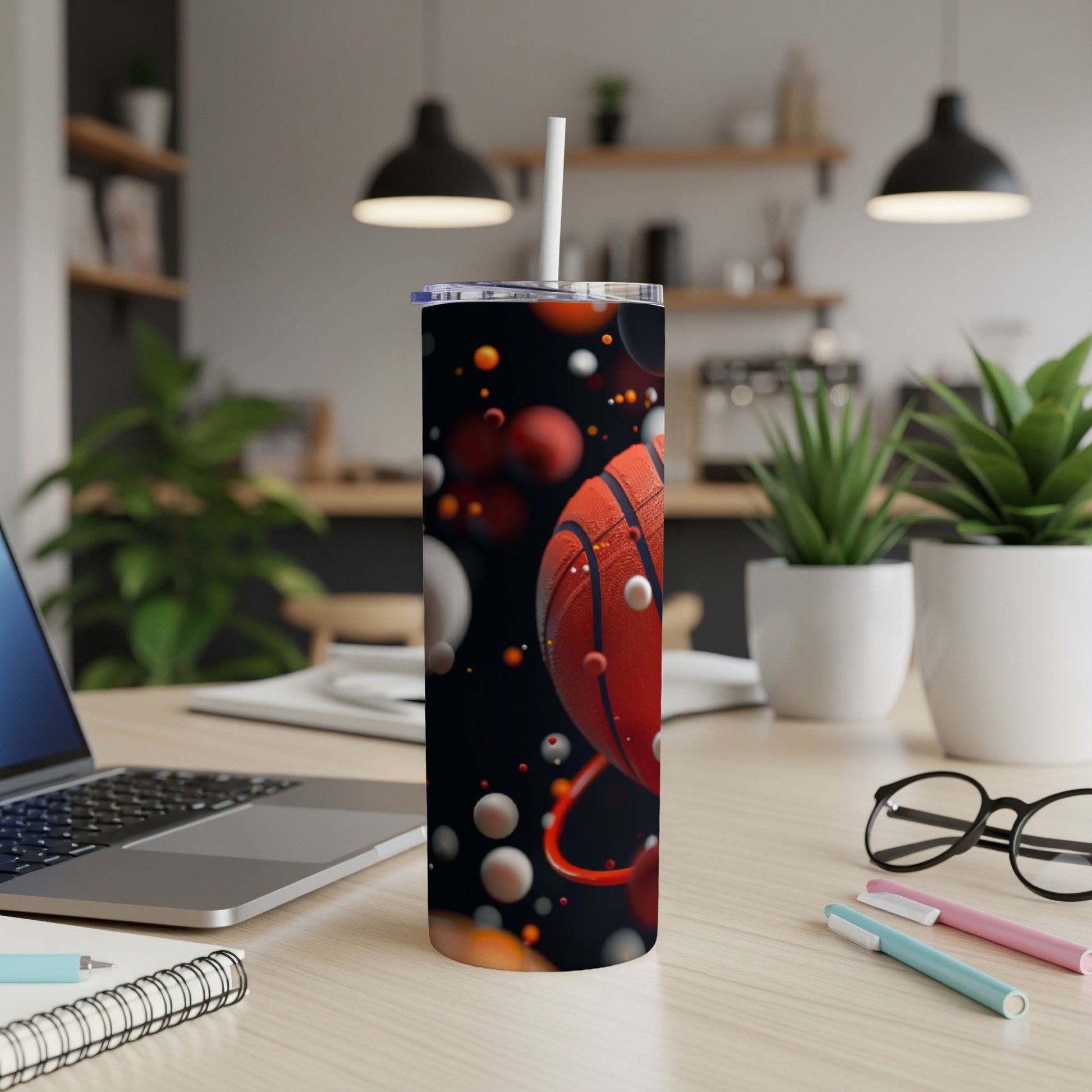 Basketball tumbler with abstract bubbles and spheres on a desk.
