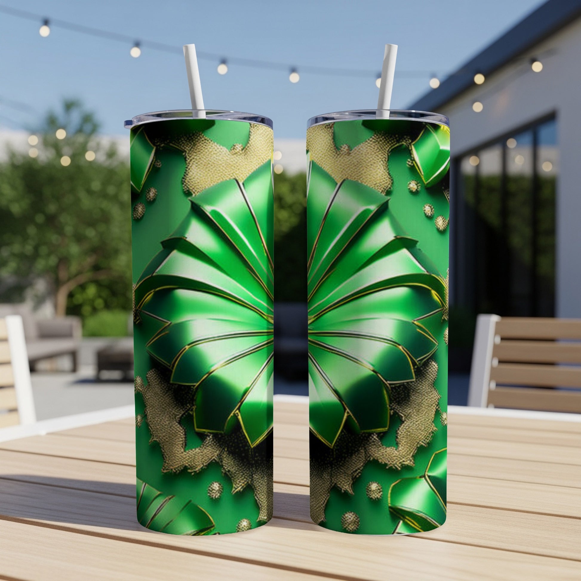 Two green tumblers with gold ribbon and shamrock designs on a table.