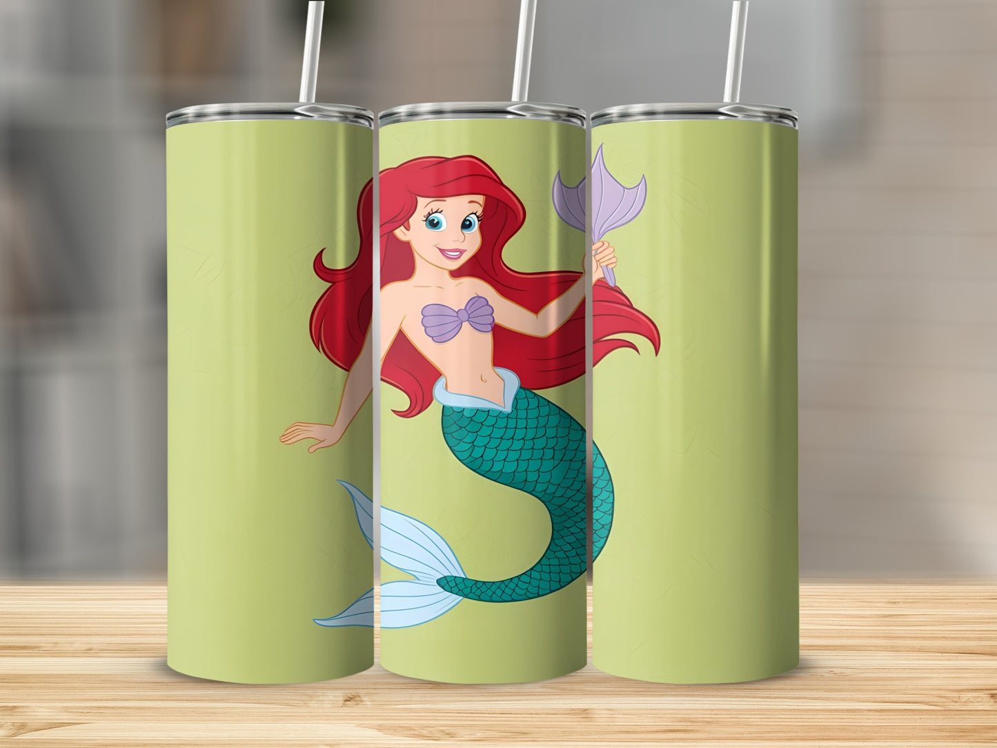 Ariel the Little Mermaid on a light green tumbler with a textured background.