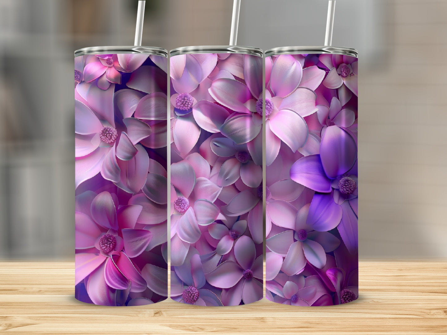 Three tumblers with a pink and purple floral pattern.