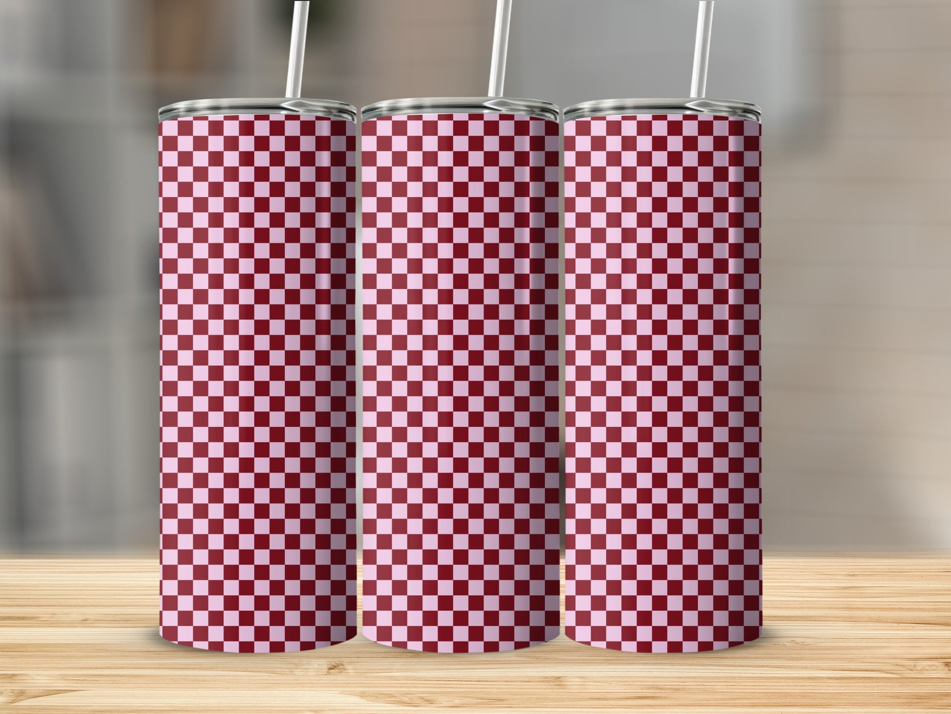 Three tall tumblers with a red and white checkered pattern.