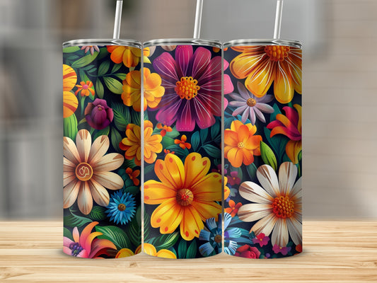 Three tumblers with colorful floral designs and straws.