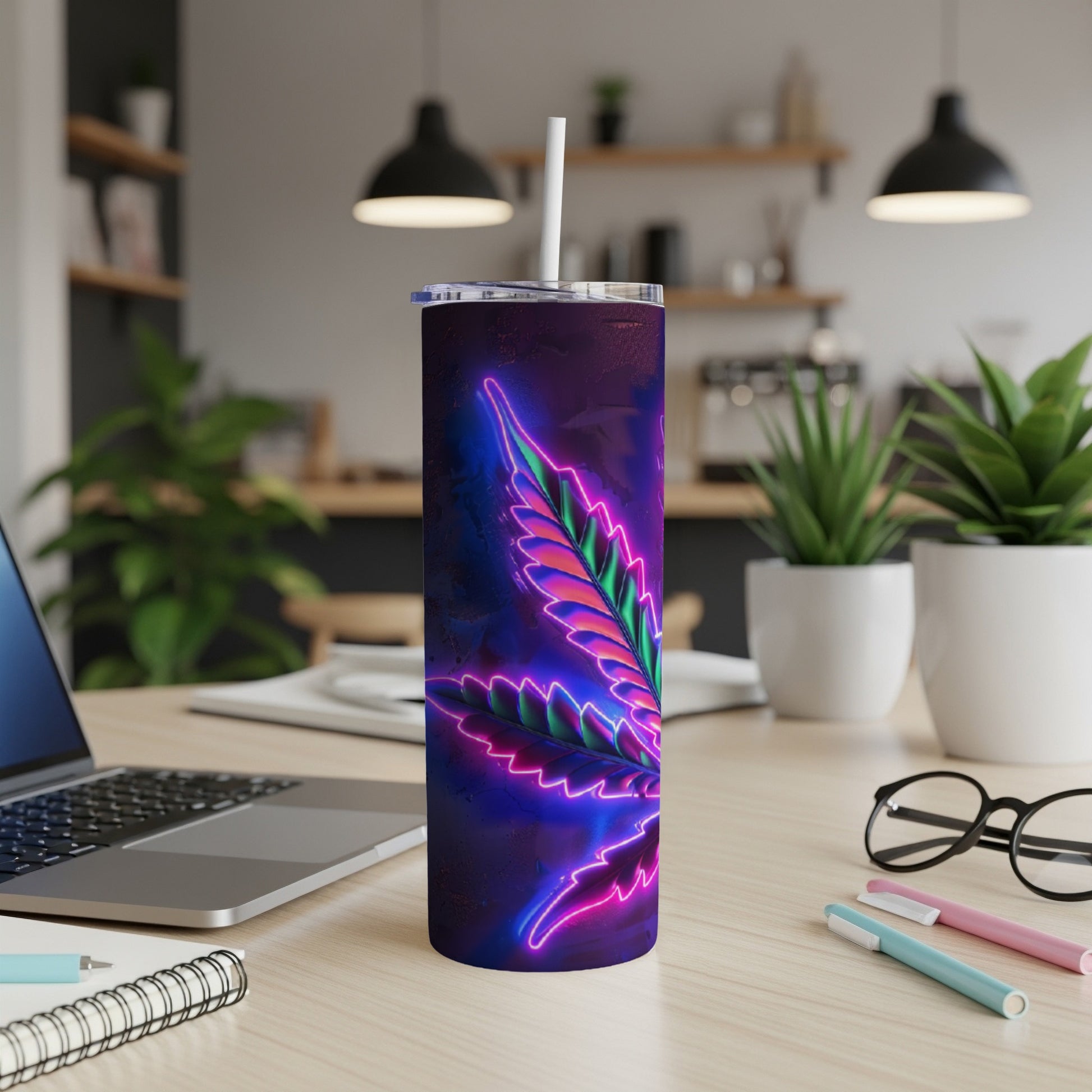 Neon cannabis leaf on a purple tumbler with a straw, on a desk.