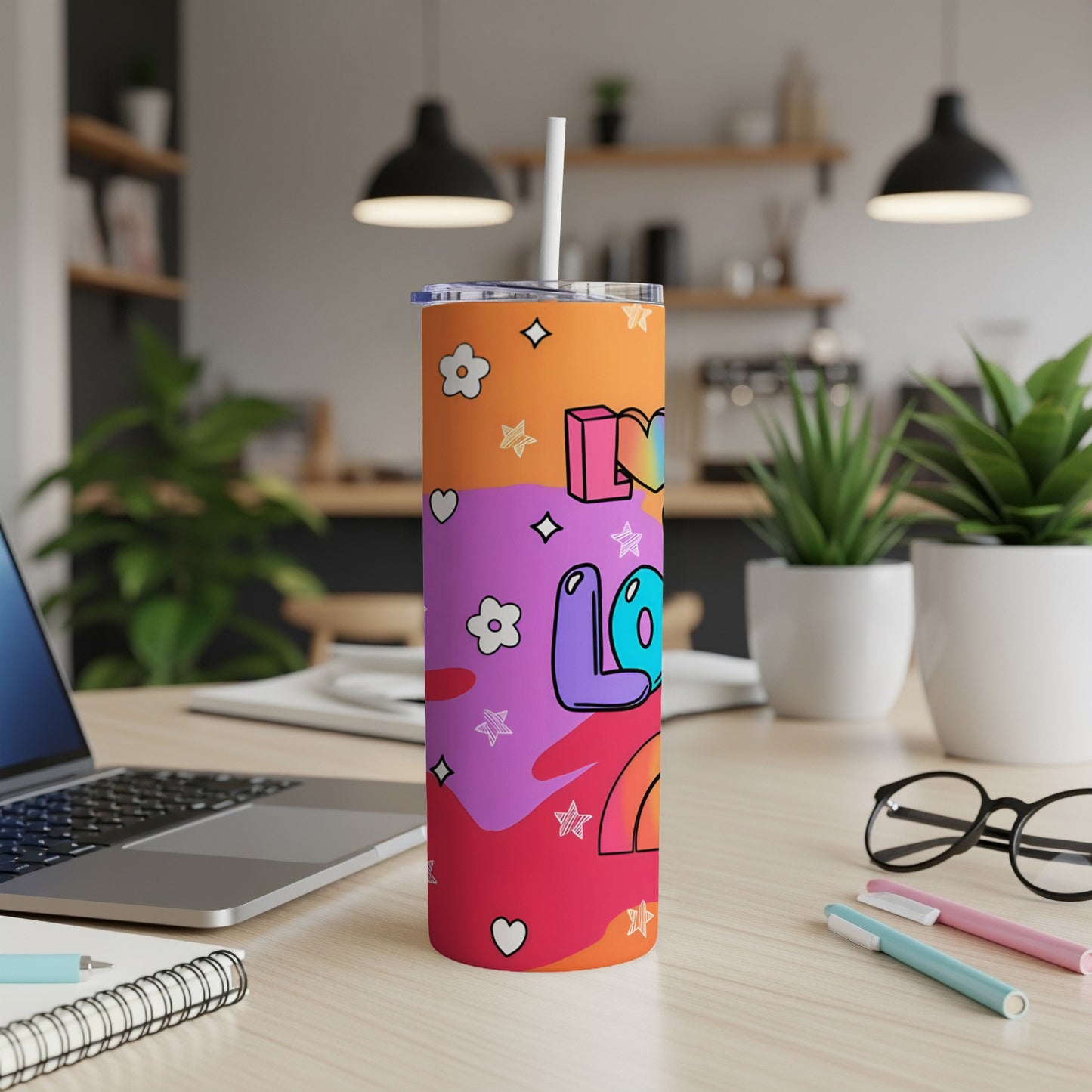 Tumbler with "Love" text and colorful abstract graphics.