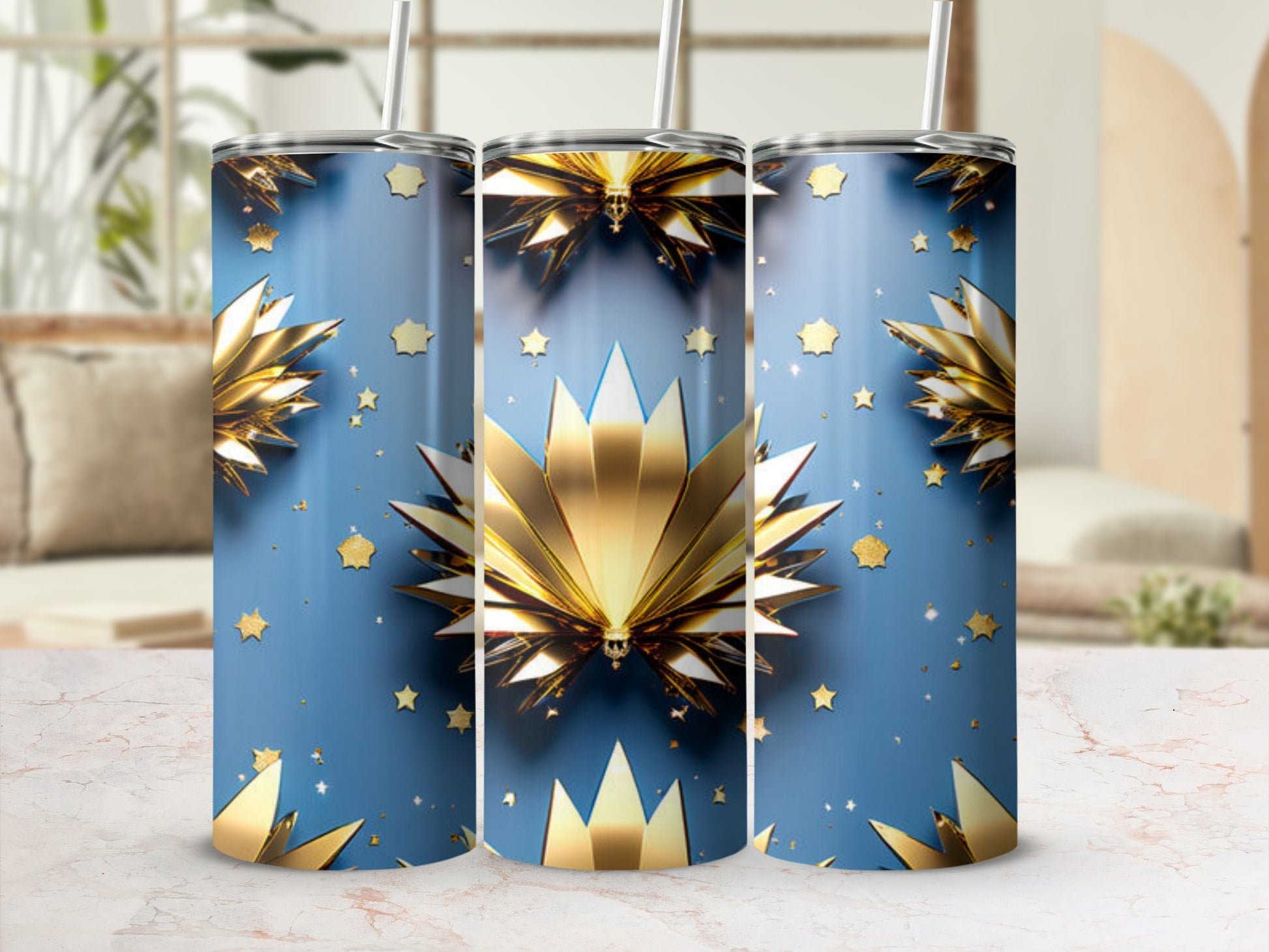 Three blue tumblers with gold star and fanburst patterns.