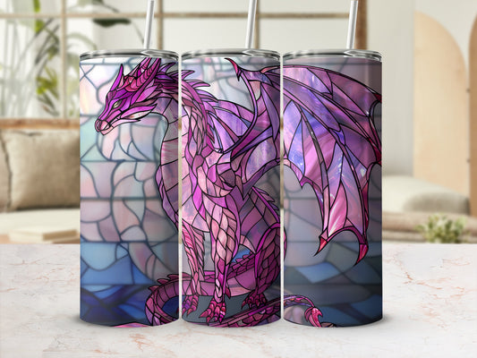 Stained glass dragon design on a tumbler with straw, in front of a window.