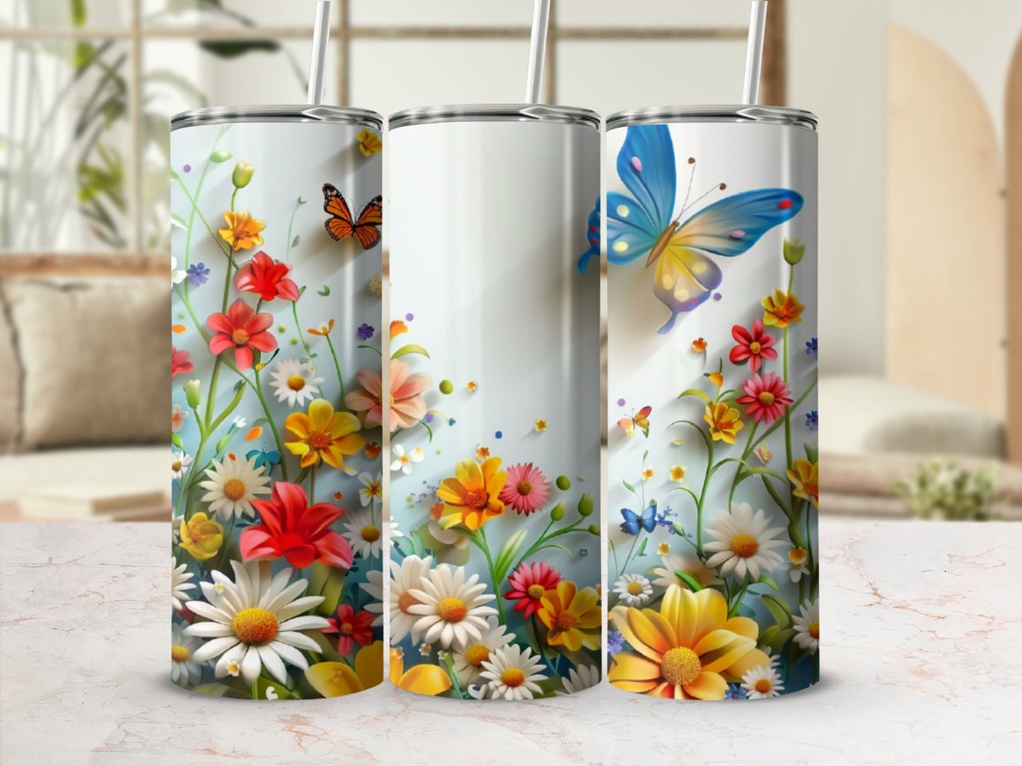 Three tumblers adorned with colorful wildflowers and butterflies.