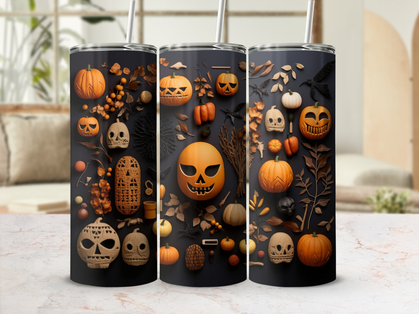 Three tumblers with Halloween patterns of pumpkins, skulls, and fall leaves.