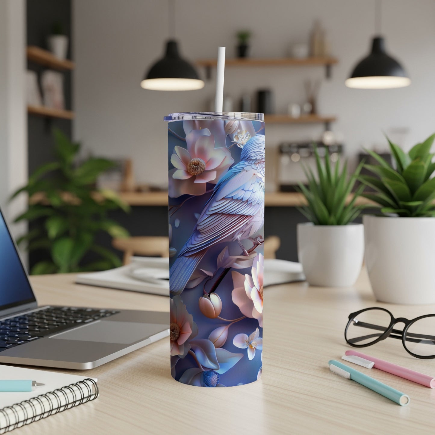 Blue bird and flowers on a white insulated tumbler with a straw.