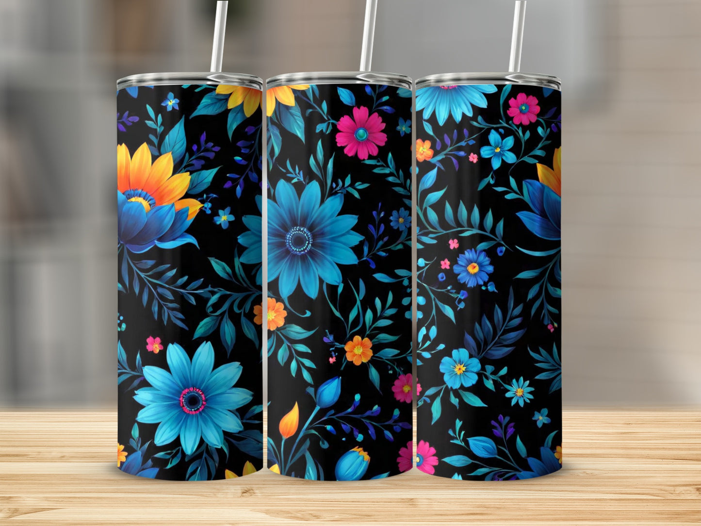 Three tumblers with a black background and vibrant floral designs.