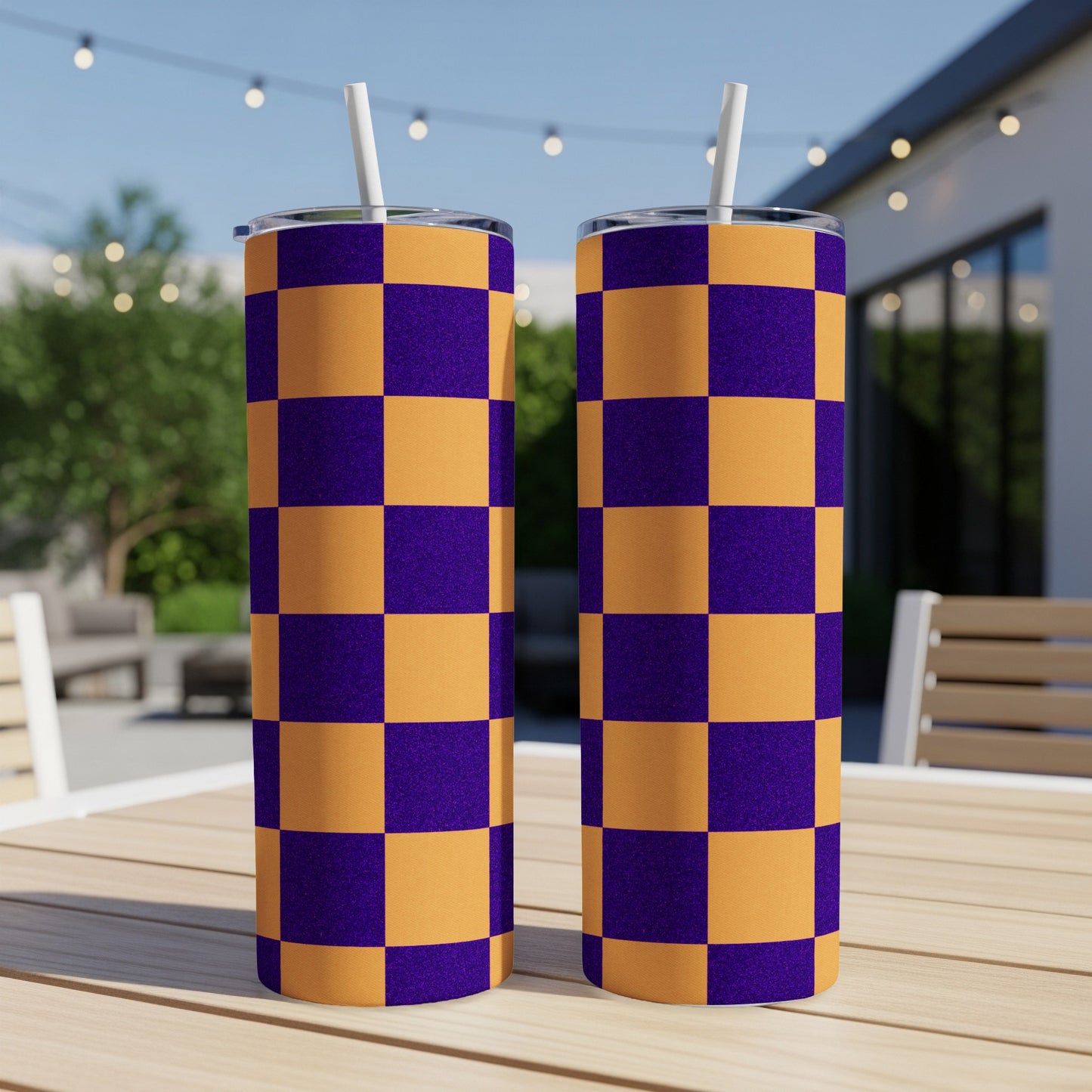 Two tumblers with a purple and orange checkerboard pattern sit on a table.