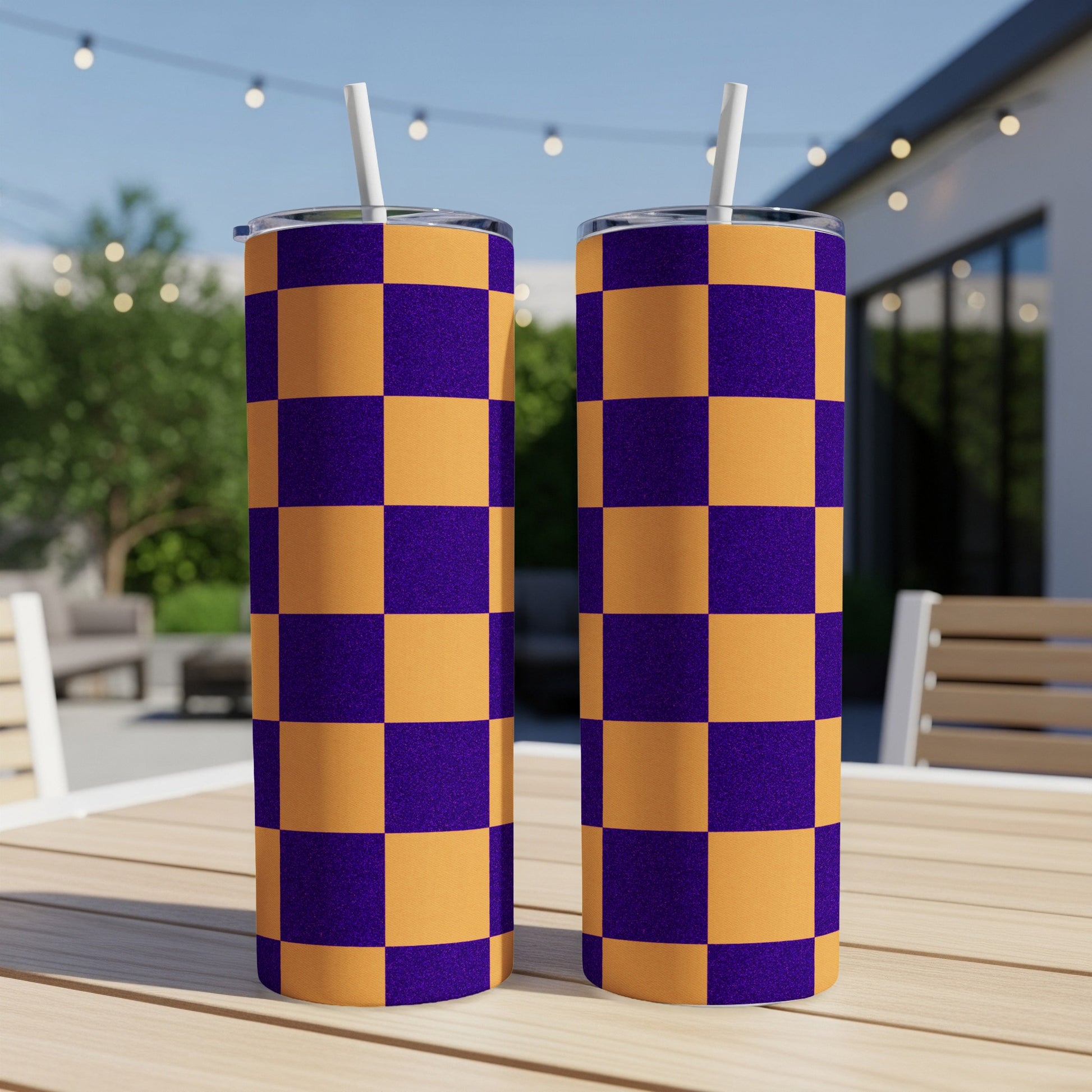 Two tumblers with a purple and orange checkerboard pattern sit on a table.
