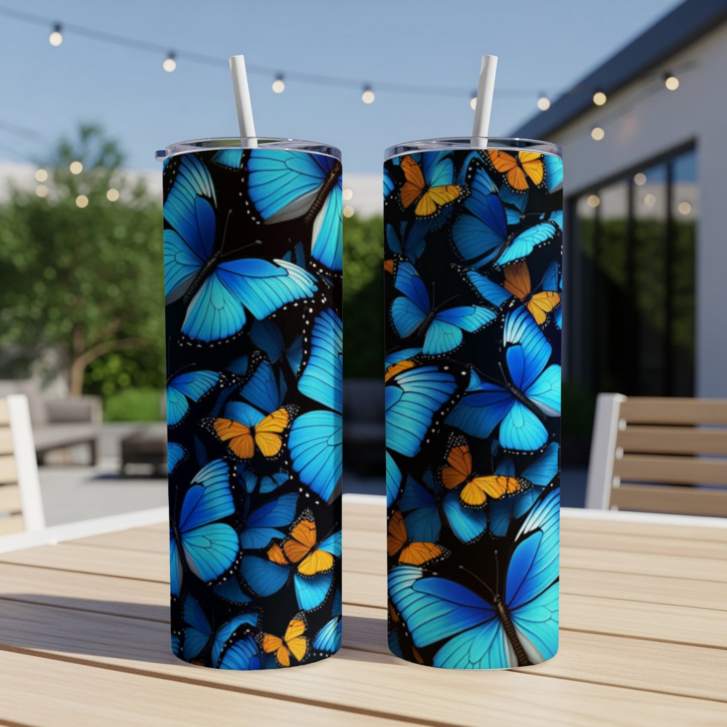 Two blue and orange butterfly pattern tumblers on a wooden table.