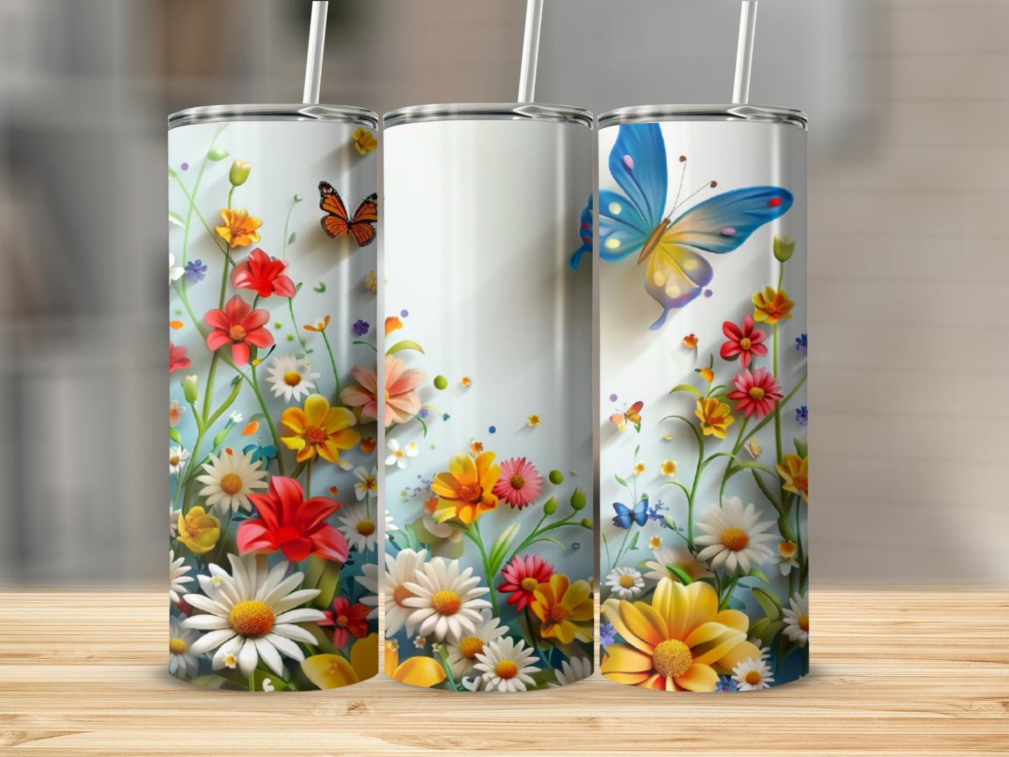 Three tall tumblers with colorful floral patterns and butterflies.
