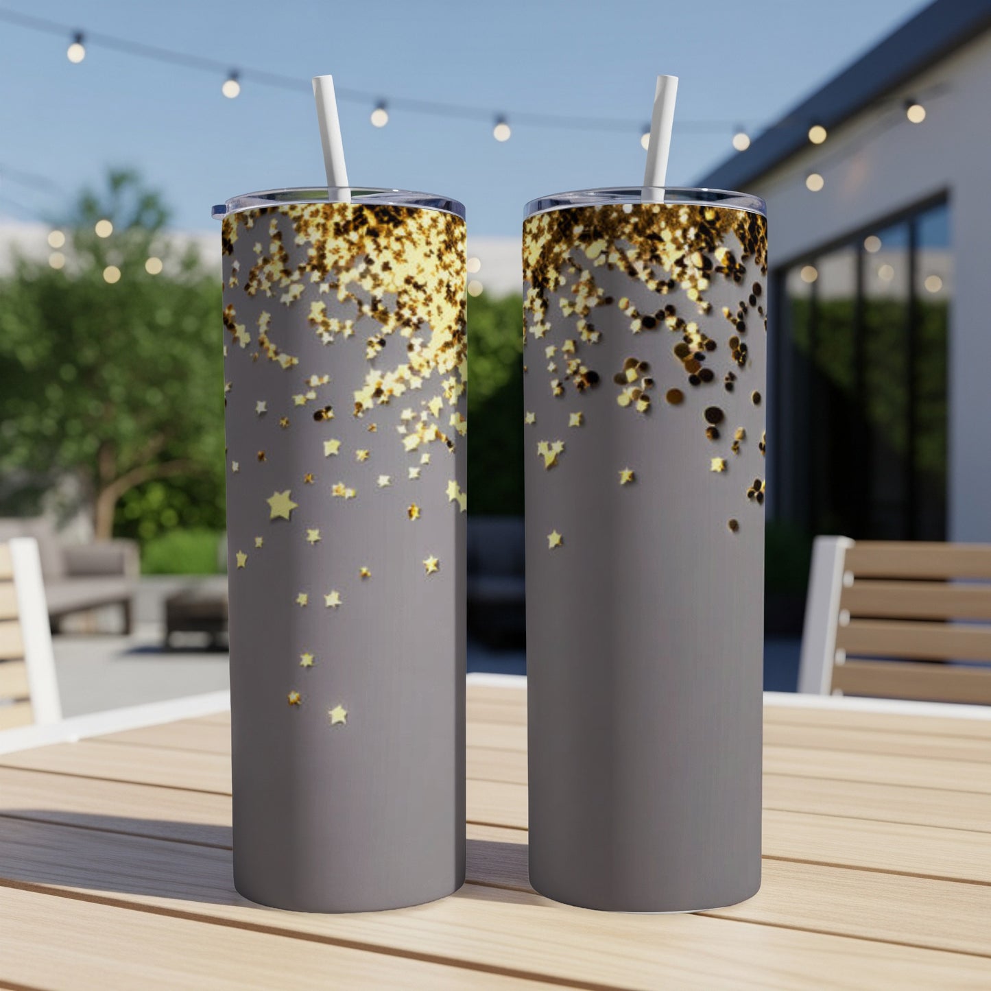 Two gray tumblers with scattered gold glitter and star confetti.