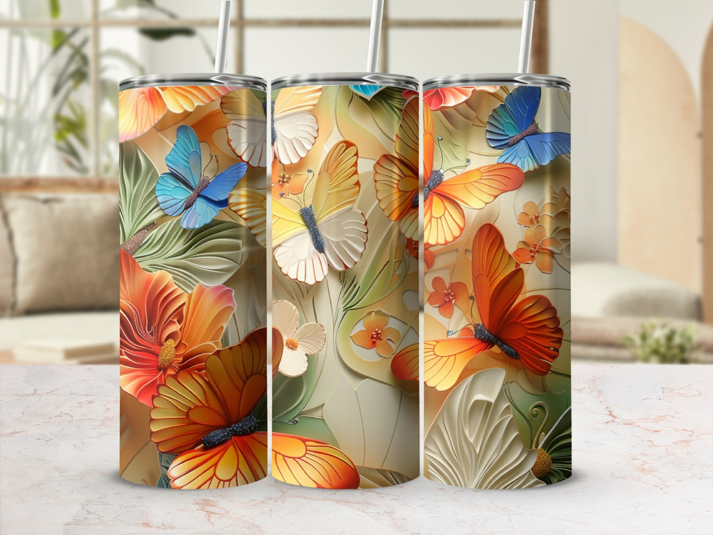 Three tumblers with colorful butterflies and floral designs.