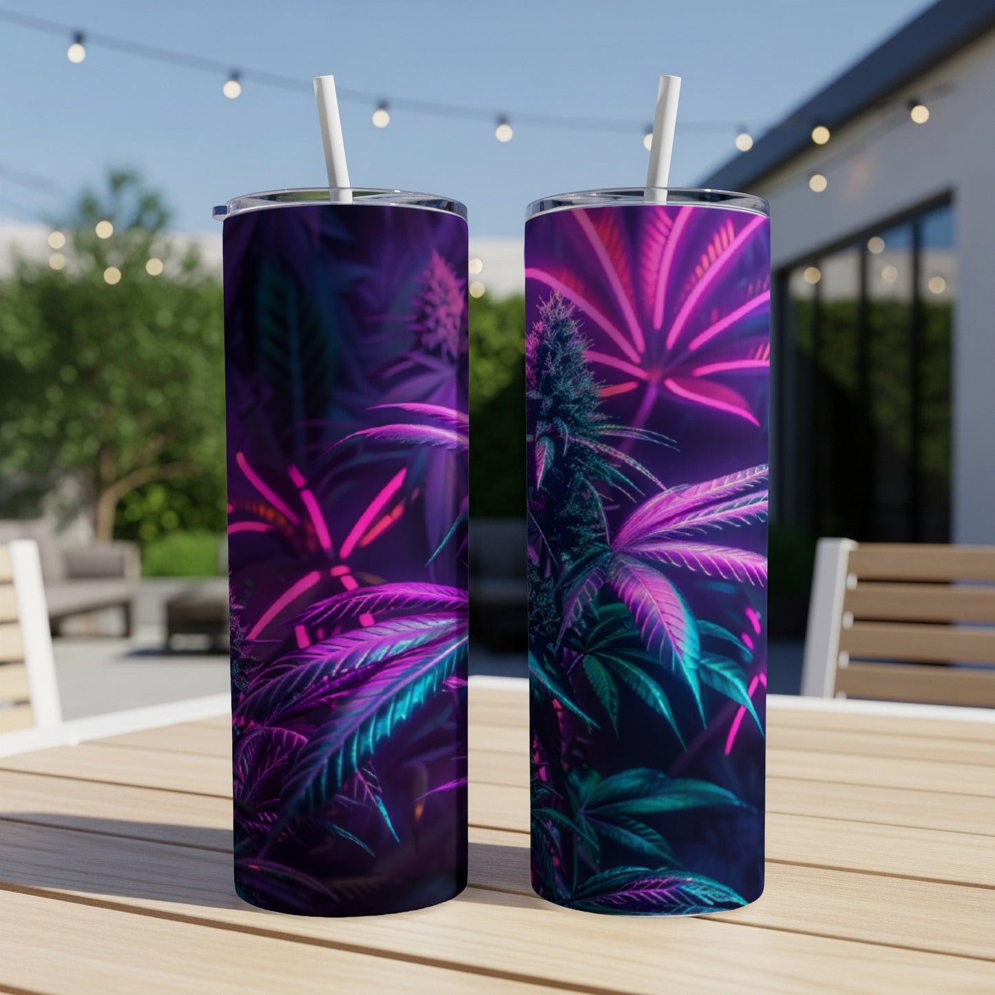 Two tumblers with purple and pink cannabis leaf design on outdoor table.