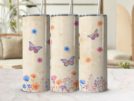 Three tumblers with floral and butterfly design on a light, textured background.