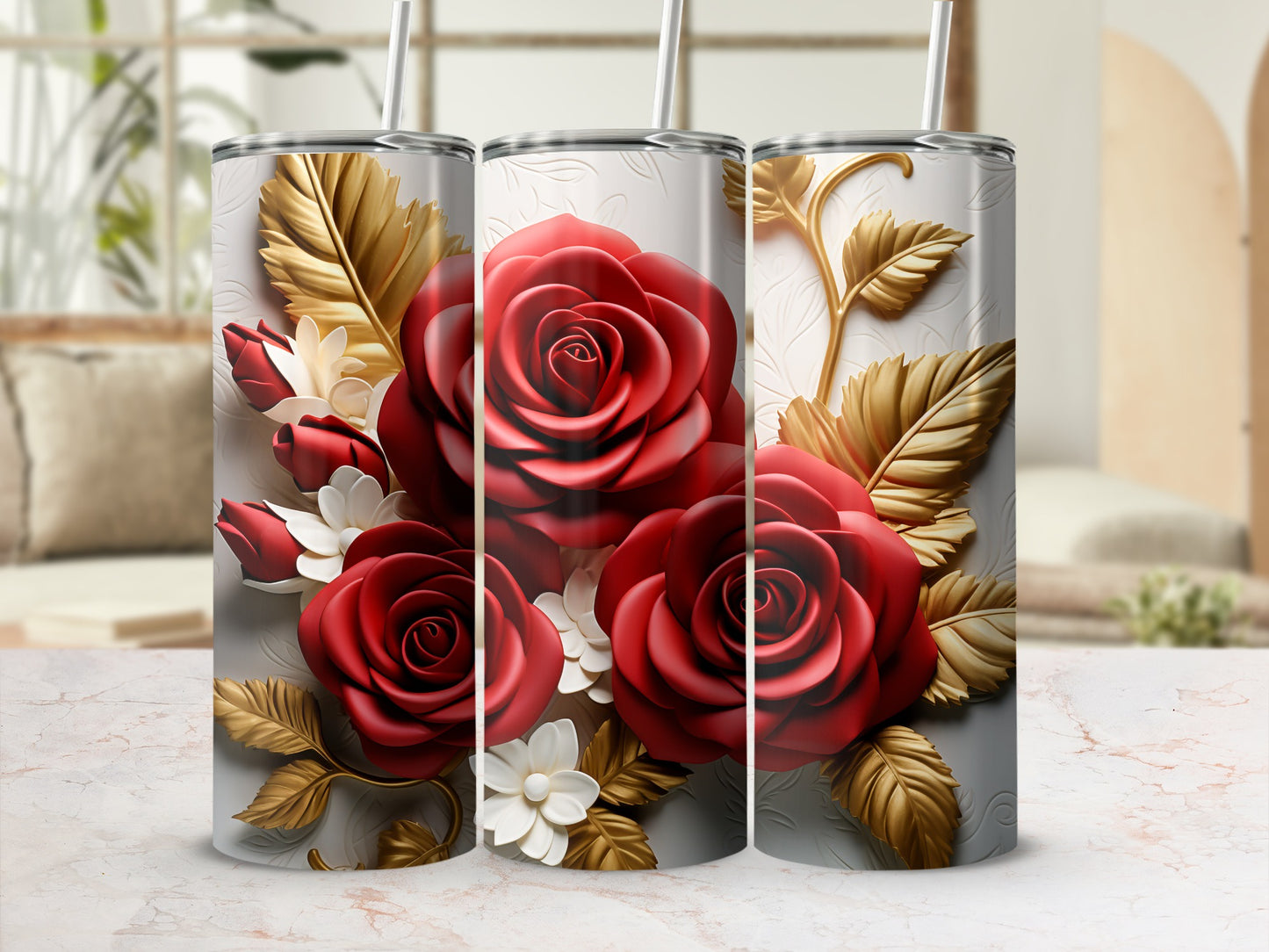 Three tumblers with red roses and gold leaves against a textured background.