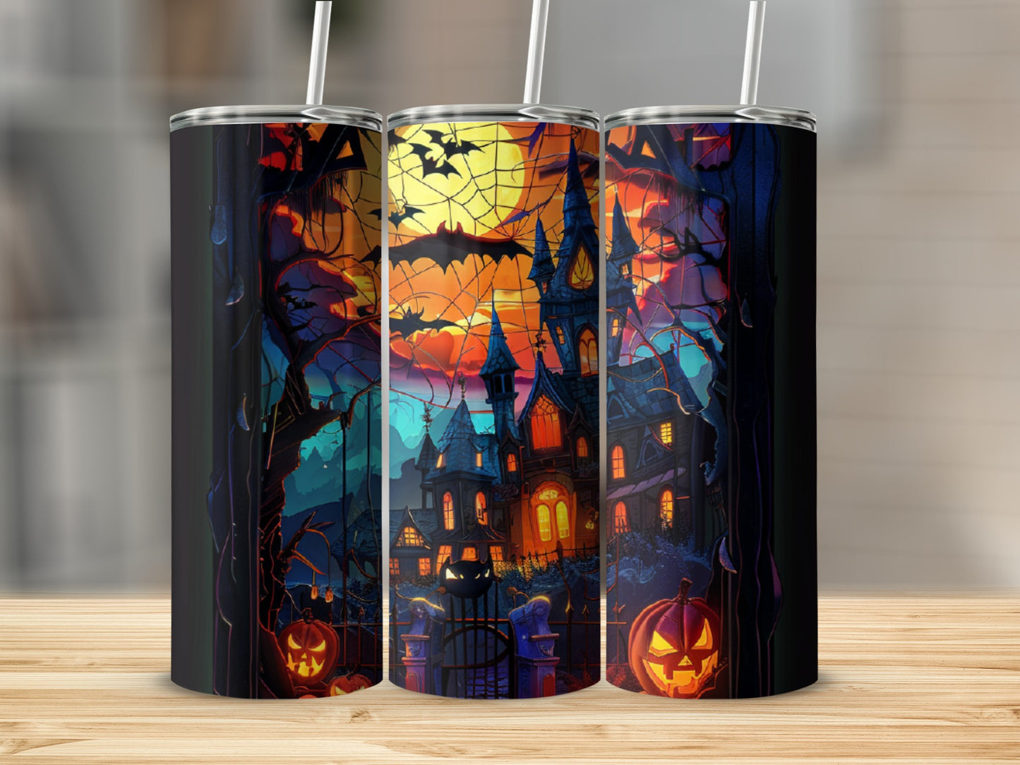Halloween castle, pumpkins, bats, and trees design on a tumbler.
