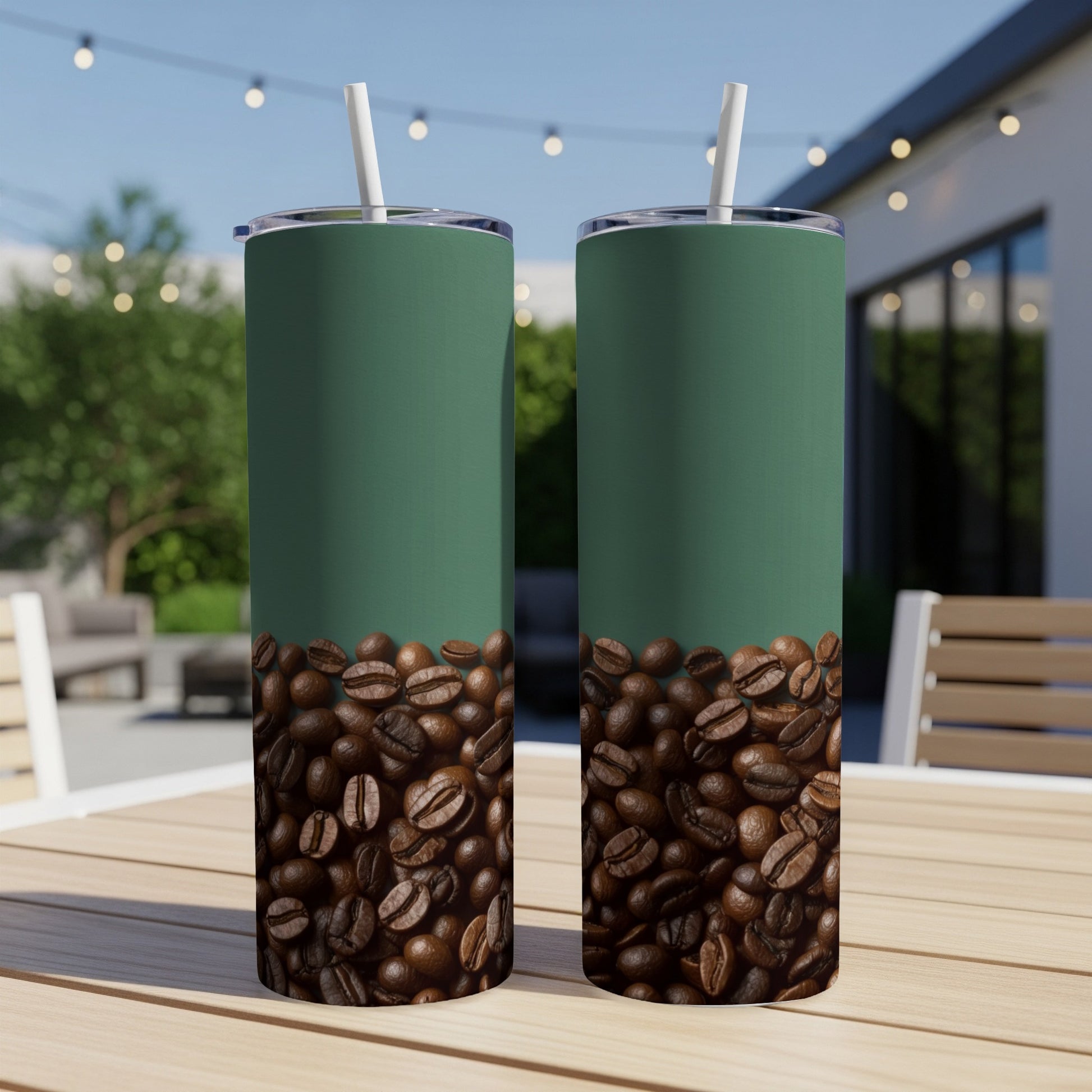 Two green tumblers with coffee beans decorate the bottom, outdoors.