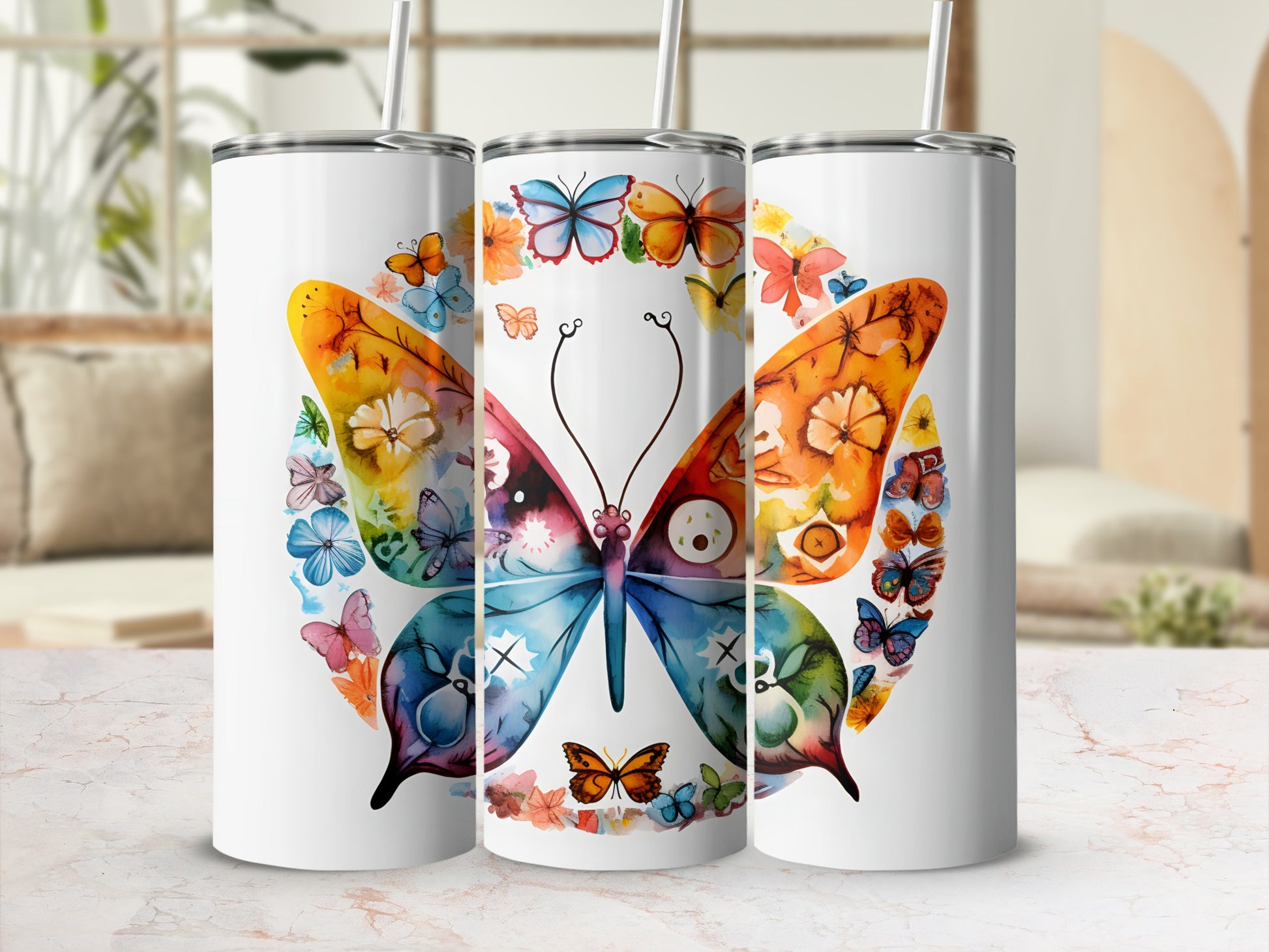 Three white tumblers with colorful butterfly designs.