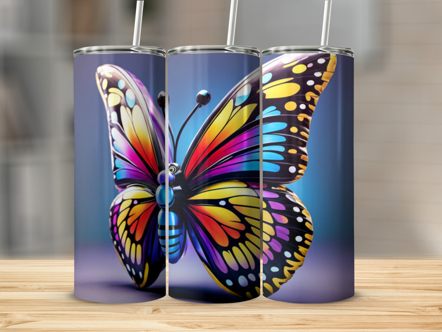 Three tumblers featuring a vibrant, colorful butterfly design.