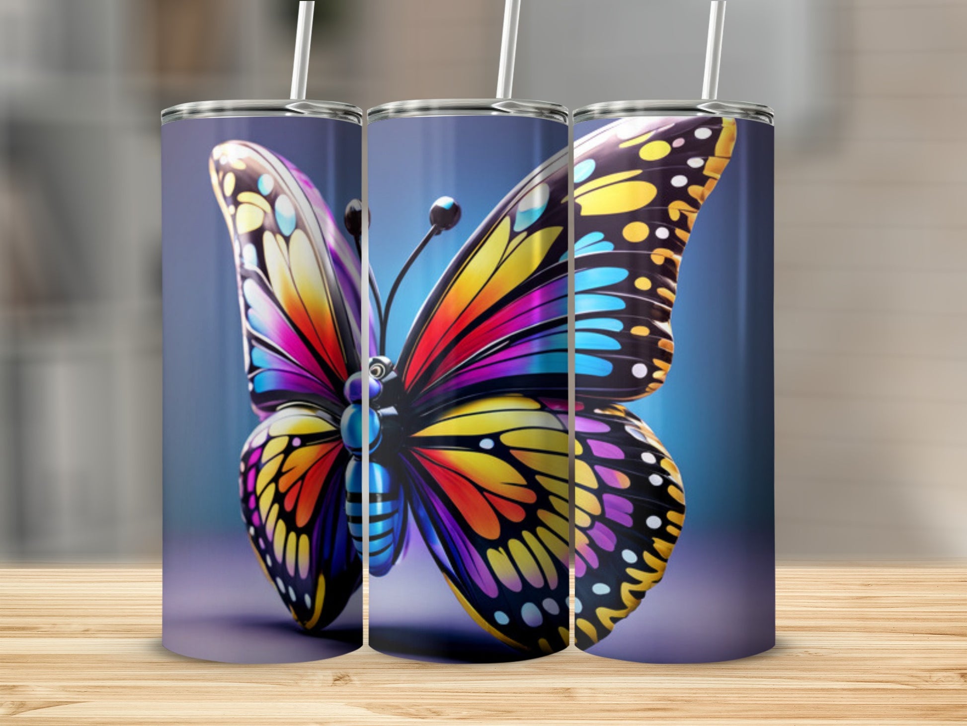 Three tumblers featuring a vibrant, colorful butterfly design.