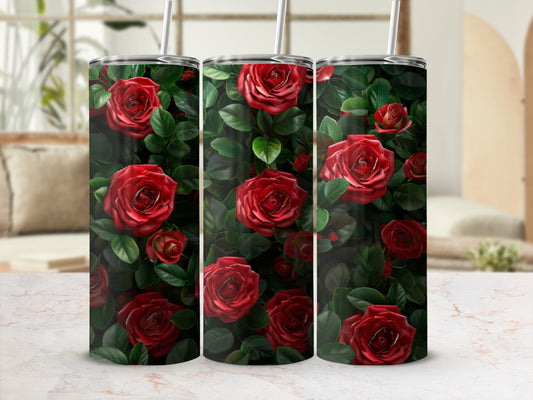 Three tumblers adorned with a pattern of red roses and green leaves.