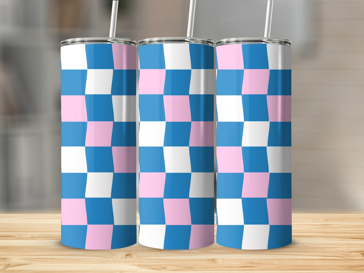 Three tumblers with a blue and pink checkered pattern and straws.