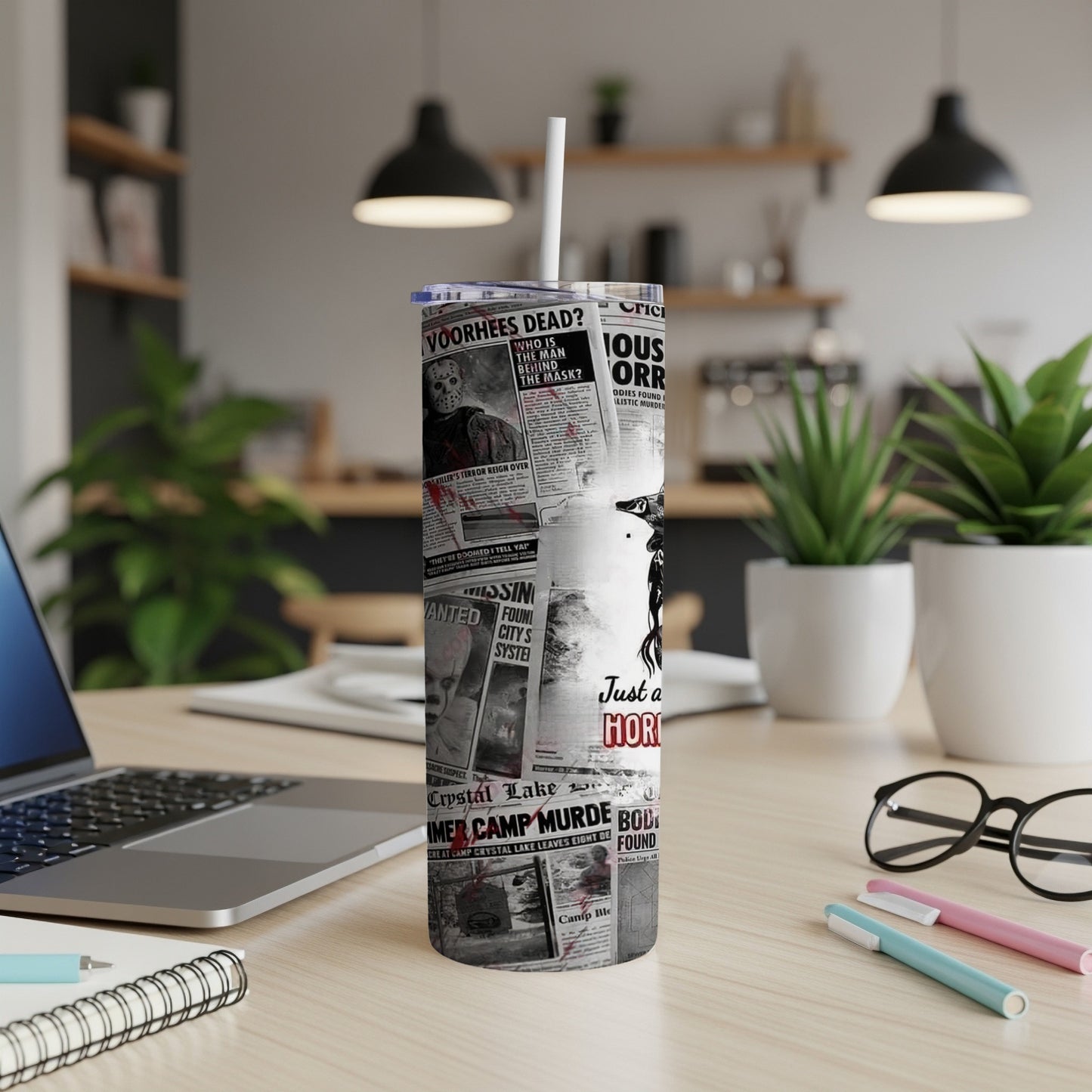 Tumbler with newspaper headlines and horror movie images.