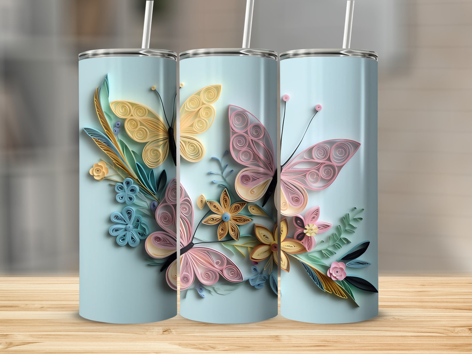 Light blue tumblers with pastel quilled butterflies and floral designs.