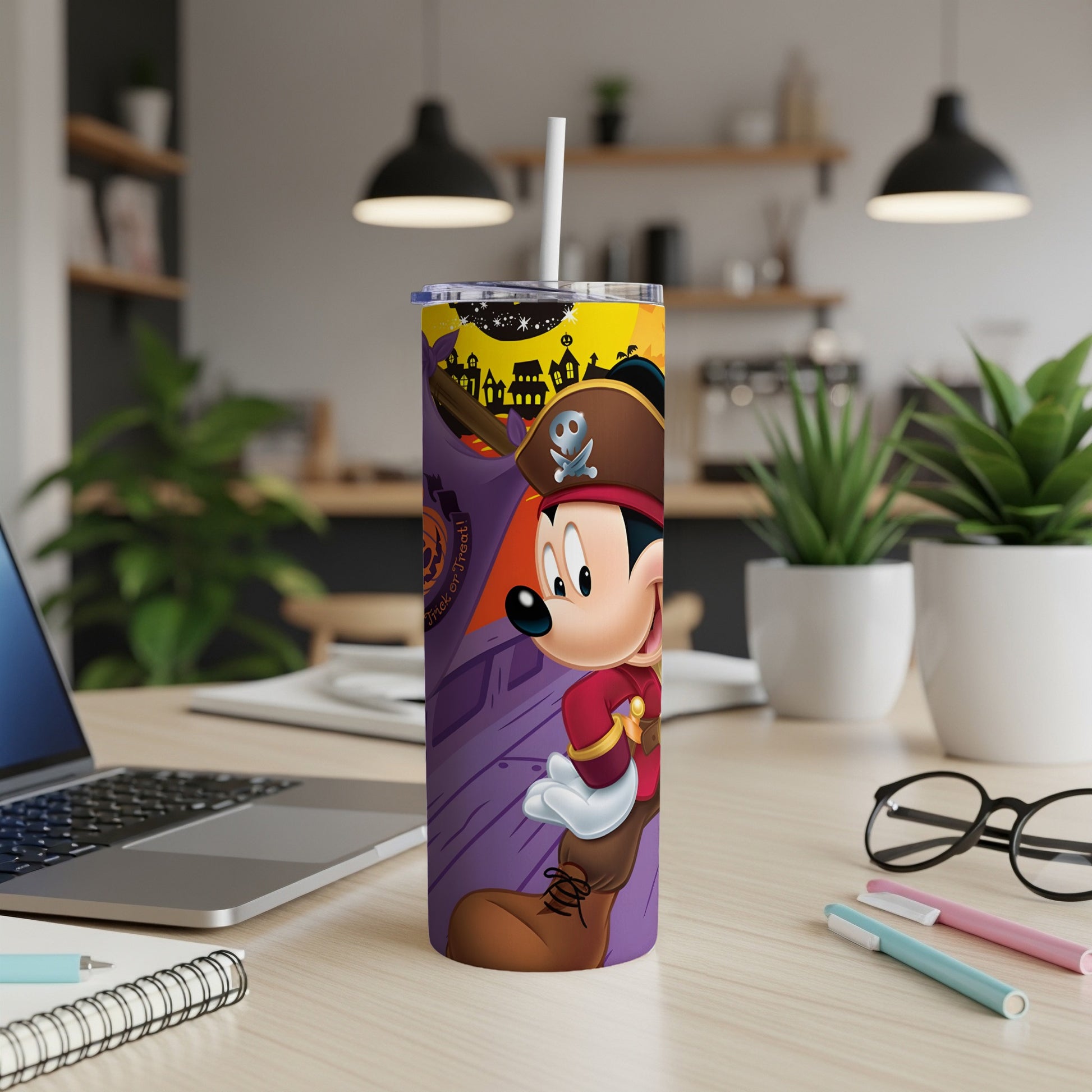 Mickey Mouse as a pirate on a purple tumbler with Halloween decorations.