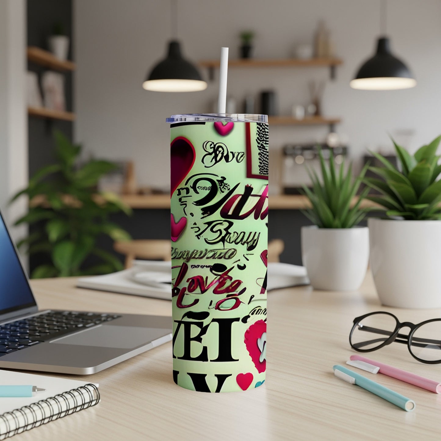 Tall tumbler with "Love you" text and heart designs, on a desk.