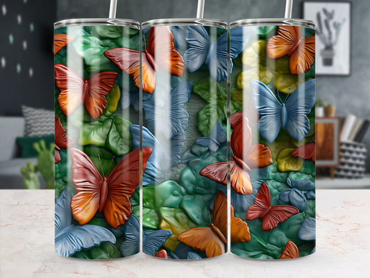 Three tumblers with a repeating pattern of colorful butterflies and green leaves.
