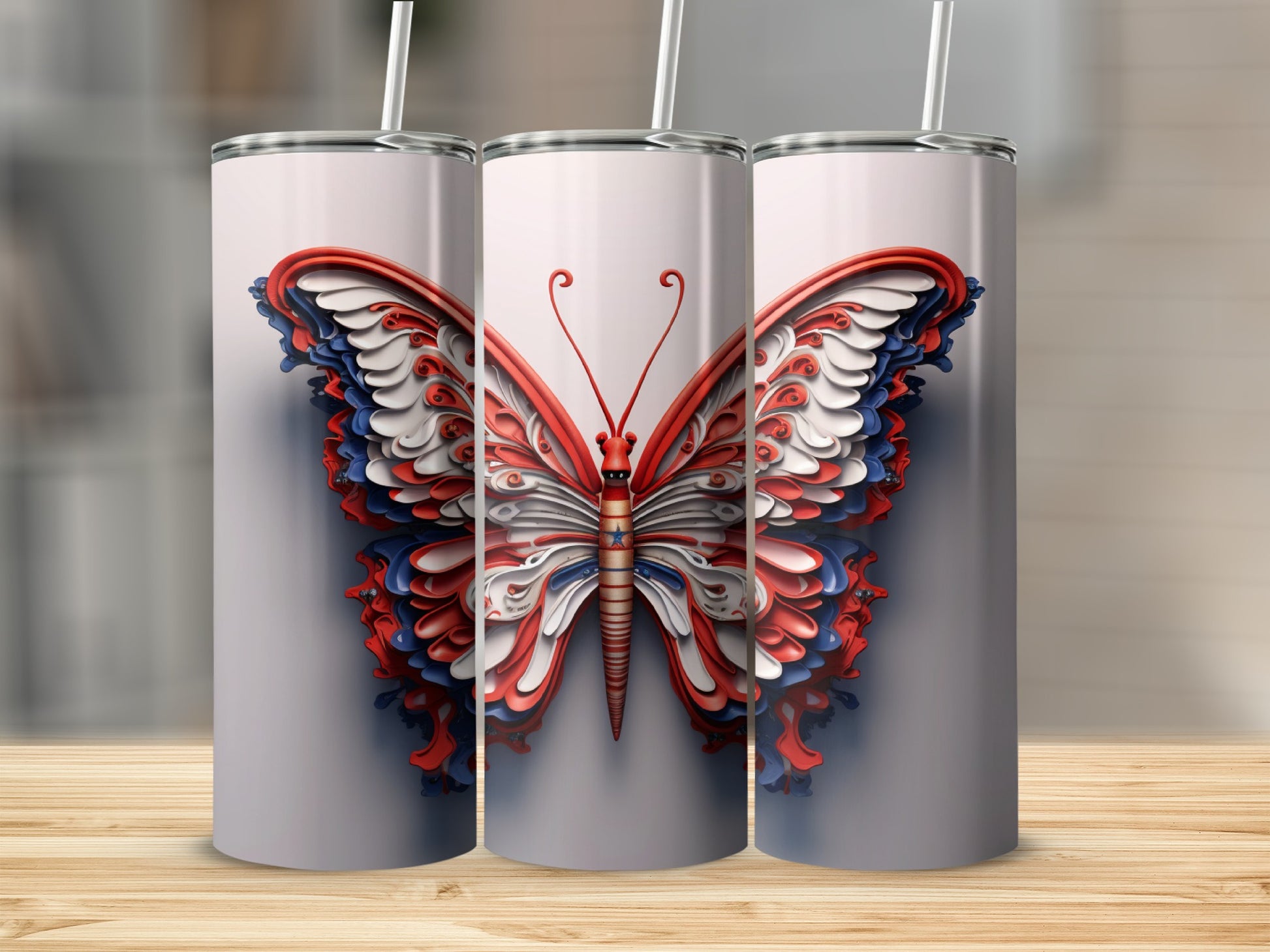 Three tumblers featuring a red, white, and blue butterfly design.