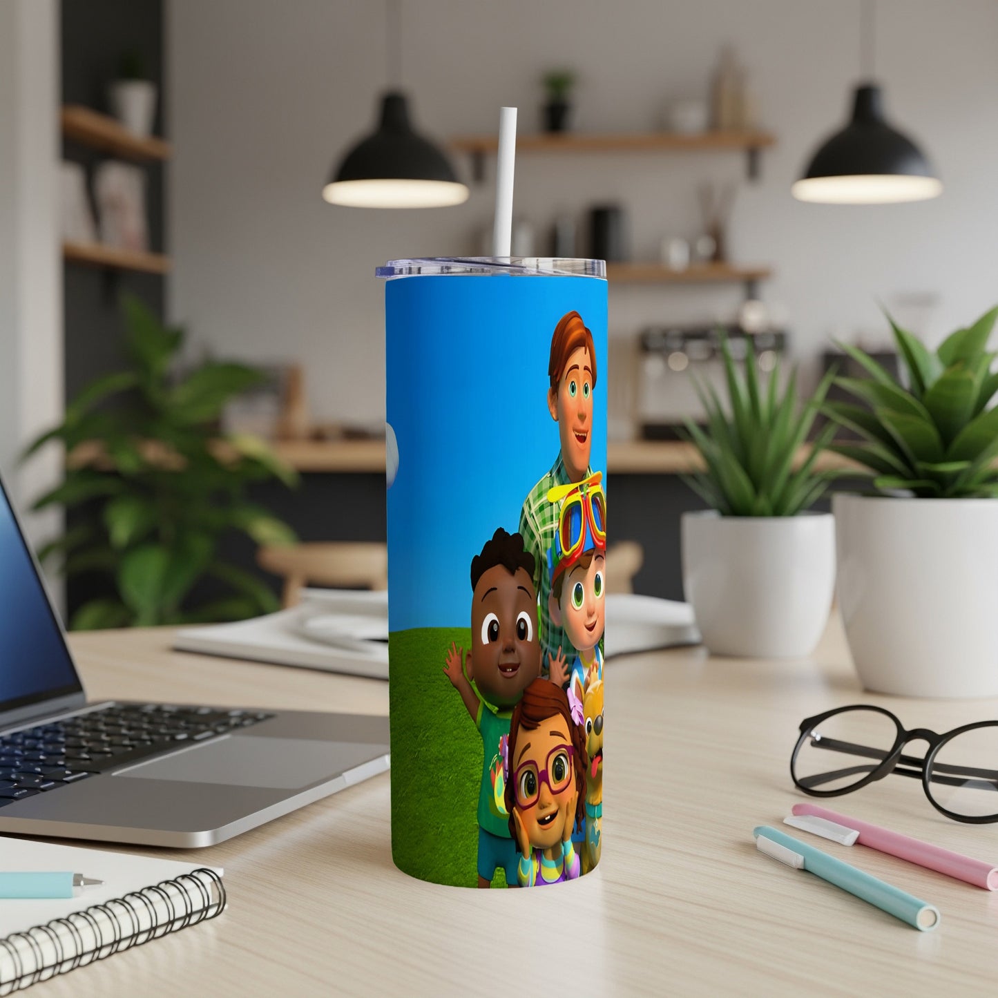 Cocomelon characters on a blue tumbler with a straw.