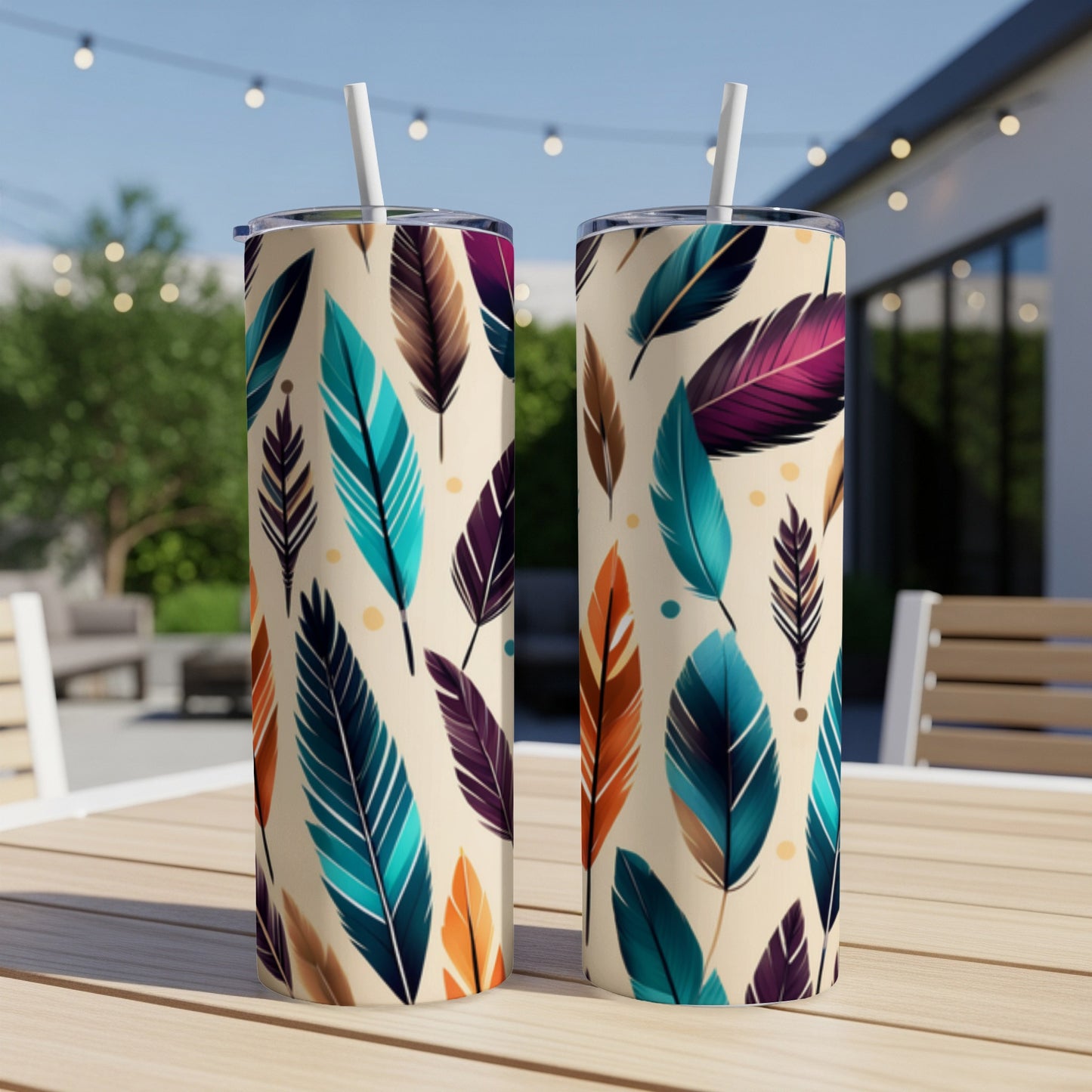 Two tall, insulated tumblers with a colorful feather pattern.