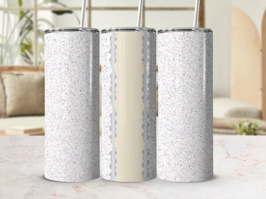 Three glitter tumblers with straws displayed on a marble surface.