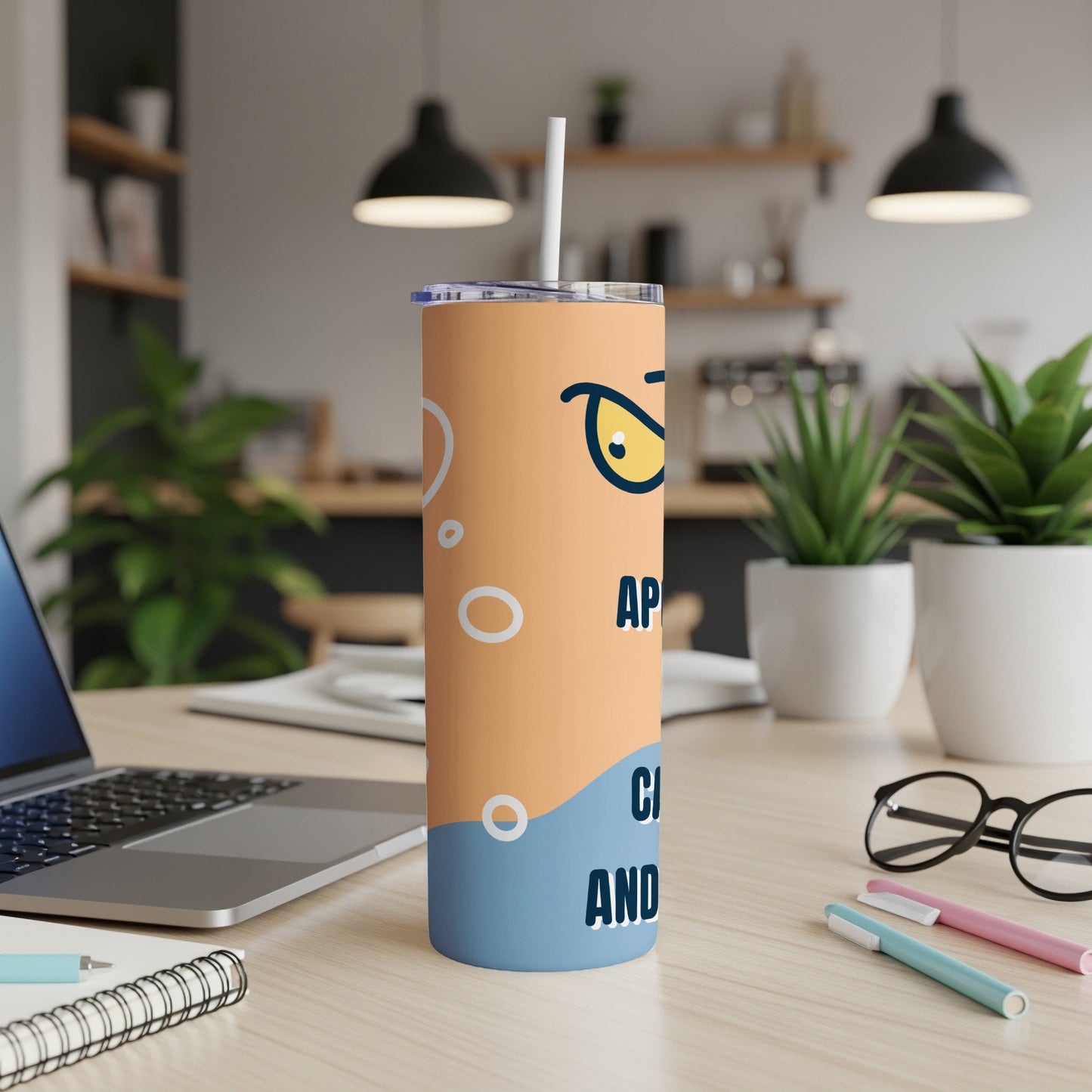 Orange and blue tumbler with cartoon eyes and text "APPLY AND".