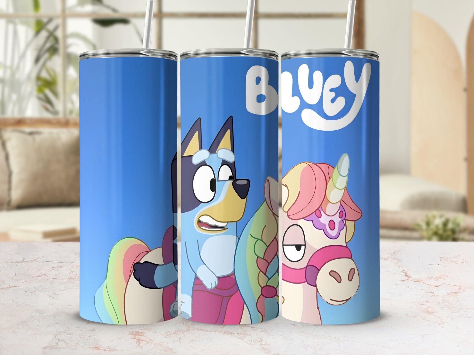 Bluey and Bandit characters on a blue tumbler with unicorn and rainbow accents.