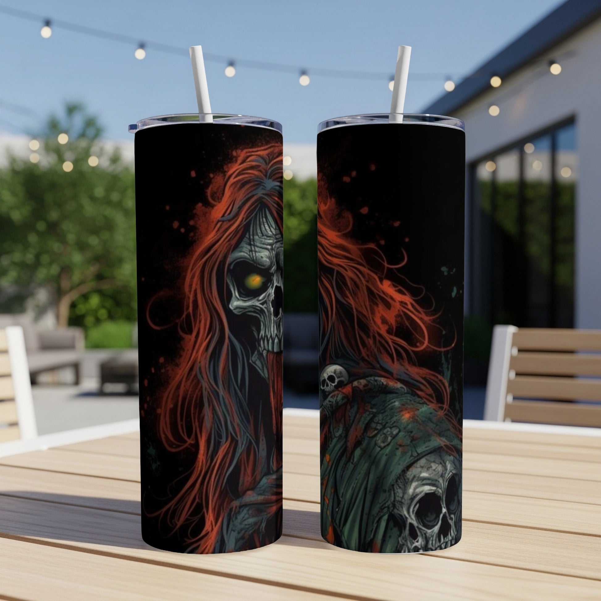 Two tumblers with gothic skull art, featuring fiery red hair and dark, eerie details.