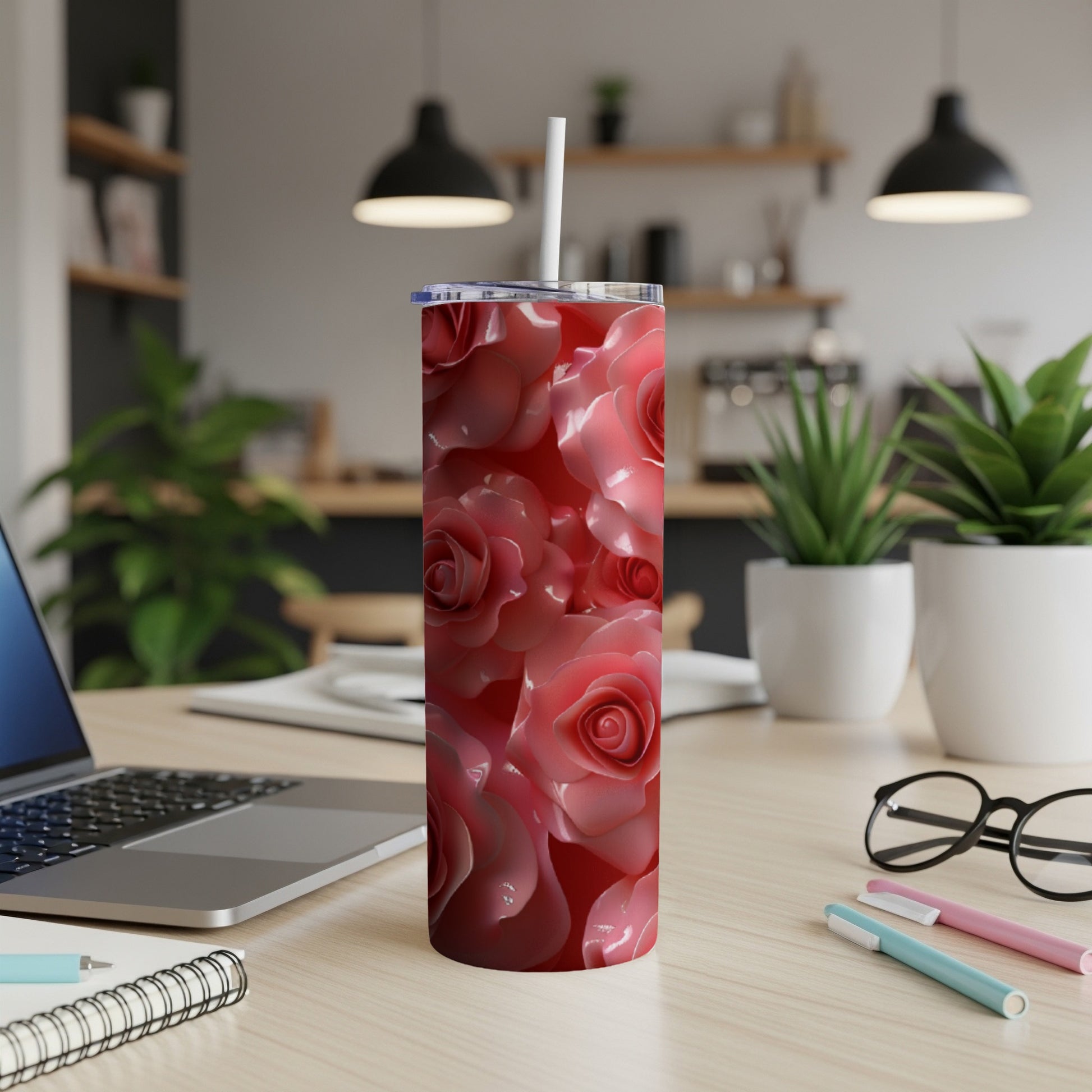 Pink roses cover a stainless steel tumbler with a white lid and straw.