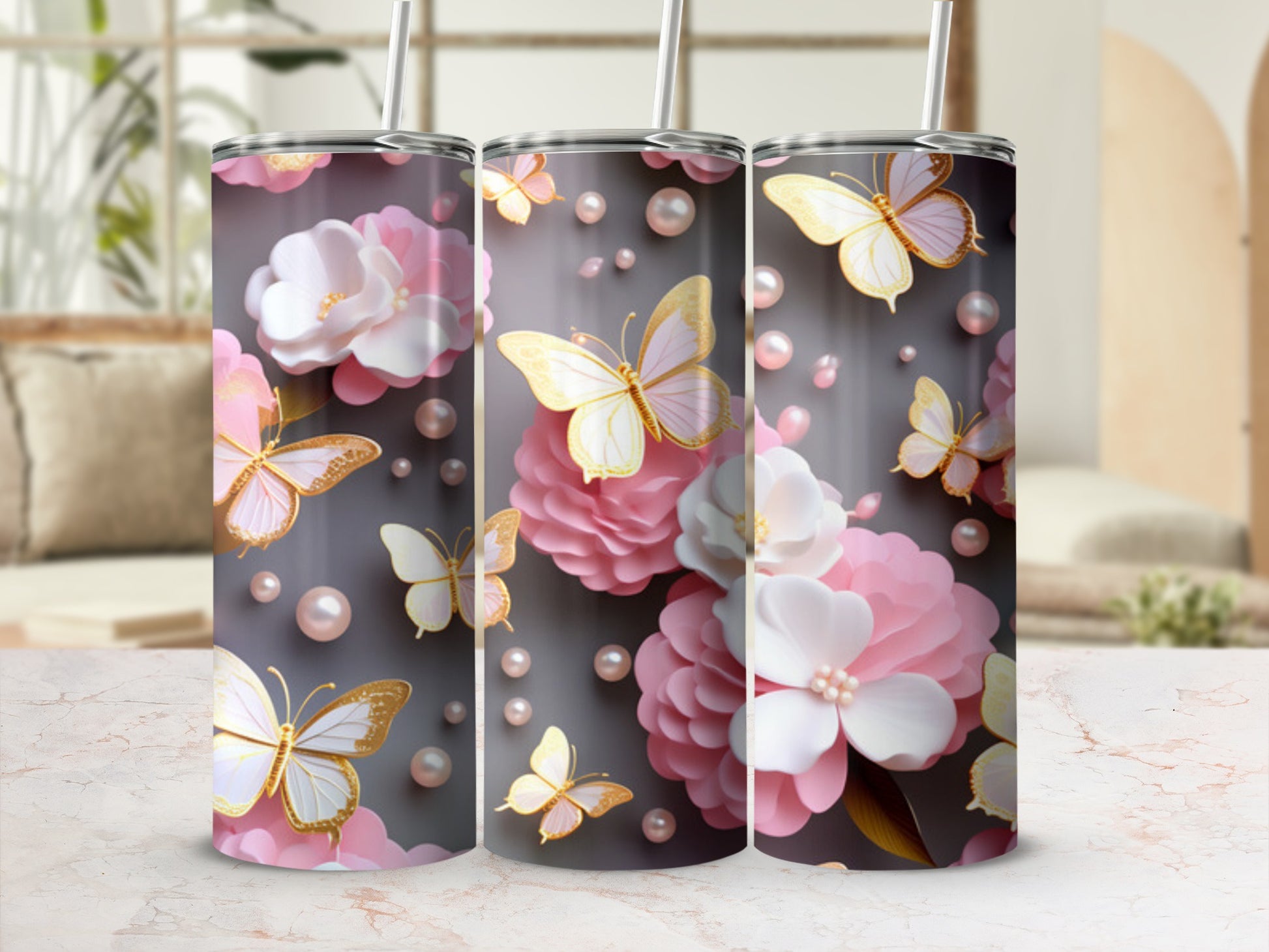 Three tumblers with pink flowers and golden butterflies on a gray background.
