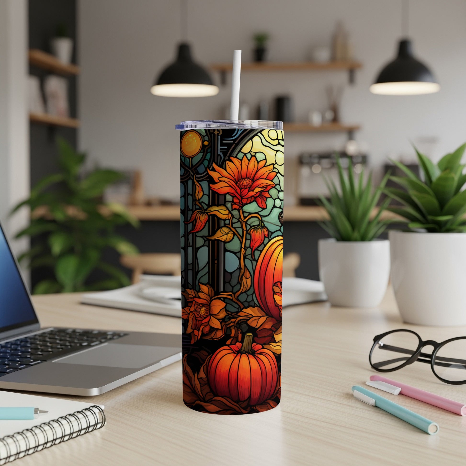 Pumpkin and floral stained glass design on a tumbler, with a straw.