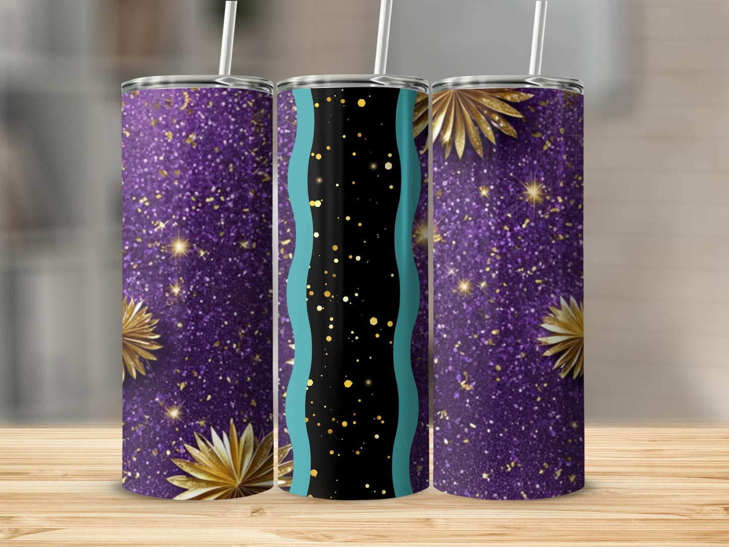 Three glitter tumblers with gold starbursts and teal accents on wood surface.
