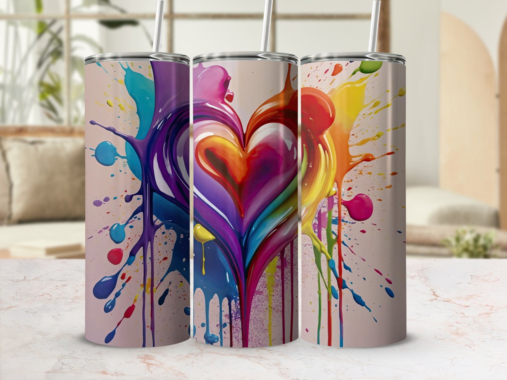 Three tumblers with colorful heart-shaped paint splatters.