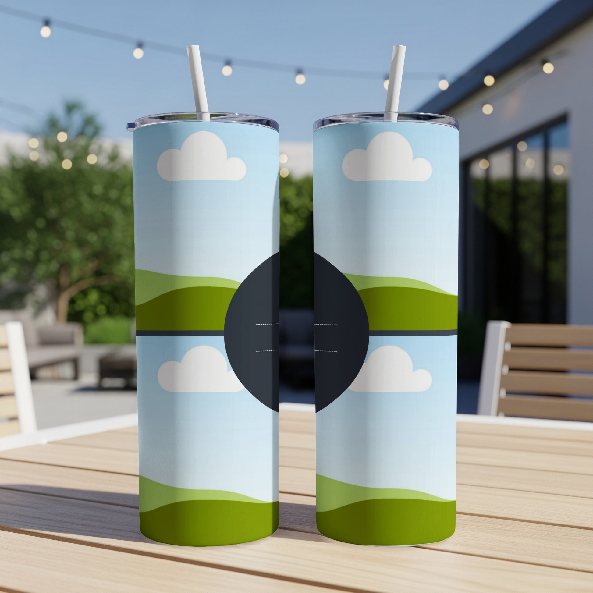 Two tumblers with a cartoon sky and rolling green hills design.